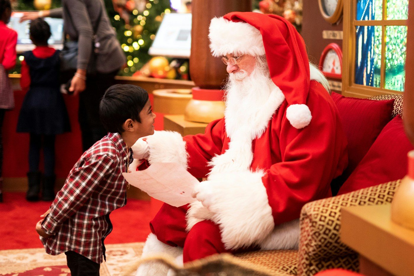A boy talking to Santa Claus