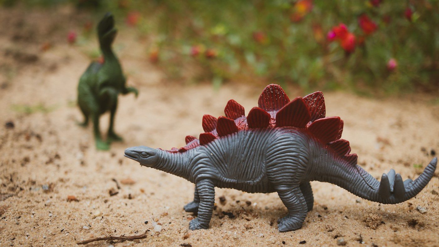 Figurki dinozaurów na piasku